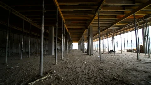 Movement of the camera between the building supports that support concrete Stock Footage 104932924