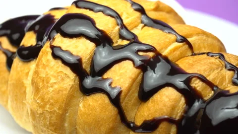 Movement of the camera at the drop of the cream. Delicious croissant Stock Footage 85867498