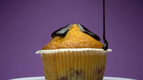 Movement of the camera at the drop of the cream on muffin or cupcake. Stock Footage 85868542