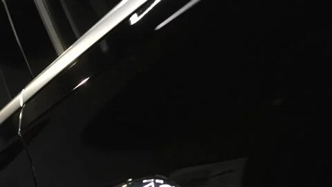 The movement of the camera past the doors, mirrors and hood black car. Stock-Footage 168380687