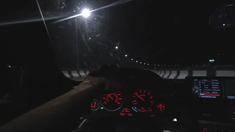Movement of car at night at high speed view from interior with driver hands 스톡 동영상 250877097