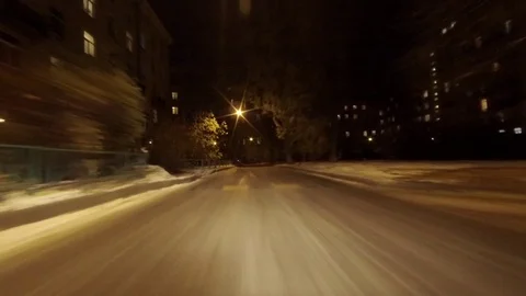 The movement of the car in the yard. Winter night Stock Footage 98854460