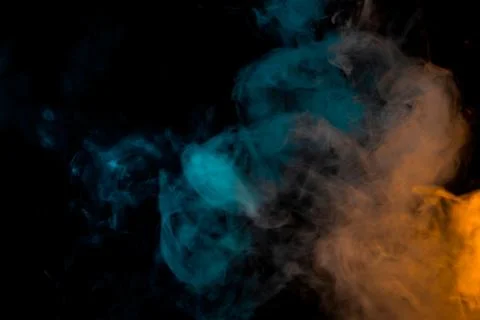 Movement of a cloud of cigarette vapour in different colours degrading from Stock Photos