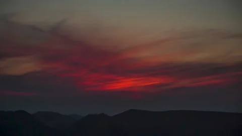 The movement of clouds across the red sky Stock Footage 151423789