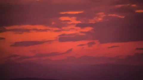 The movement of clouds across the red sky Stock Footage 151426357