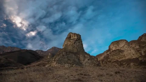 The movement of clouds across the sky over the mountains Stock Footage 149380597