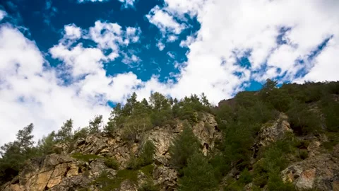 The movement of clouds across the sky over the mountains Stock Footage 149380667