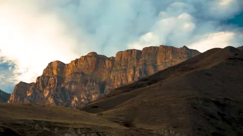 The movement of clouds across the sky over the mountains Stock Footage 149380672