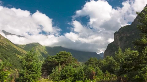 The movement of clouds across the sky over the mountains Stock Footage 149380736