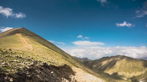 The movement of clouds across the sky over the mountains. Video stock 158458900