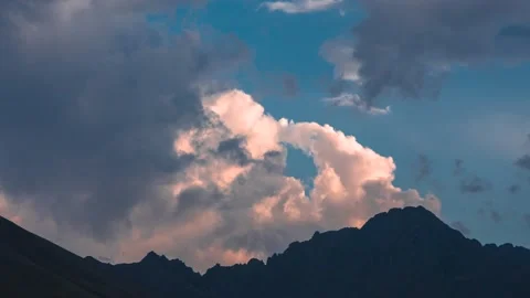 The movement of clouds across the sky over the mountains. Stock Footage 159570189