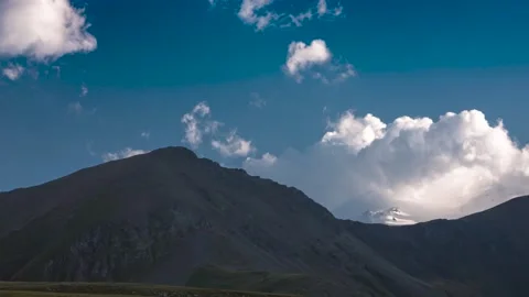 The movement of clouds across the sky over the mountains. Stock Footage 159570270