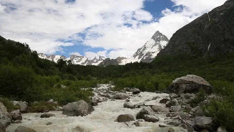 Movement of clouds and water flows in a stormy river in the mountains Stock Footage 86485704
