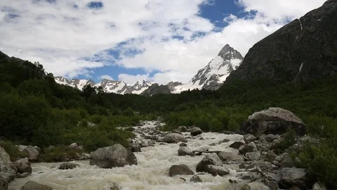Movement of clouds and water flows in a stormy river in the mountains Stock Footage 86485923