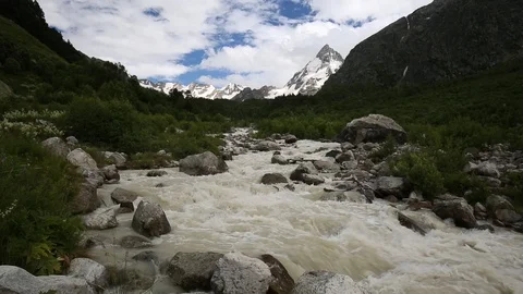 Movement of clouds and water flows in a stormy river in the mountains Stock Footage 86485947