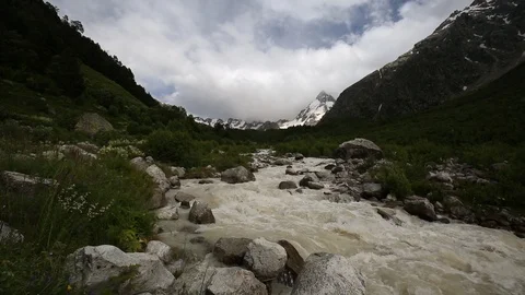 Movement of clouds and water flows in a stormy river in the mountains Stock Footage 86486137