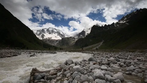 Movement of clouds and water flows in a stormy river in the mountains Stock Footage 86486359