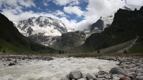 Movement of clouds and water flows in a stormy river in the mountains Stock Footage 86486561
