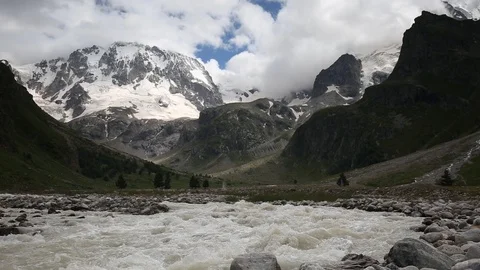 Movement of clouds and water flows in a stormy river in the mountains Stock Footage 86486854