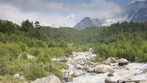 Movement of clouds and water flows in a stormy river in the mountains Stock Footage 86487429
