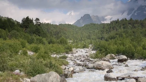 Movement of clouds and water flows in a stormy river in the mountains Stock Footage 86487795