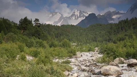 Movement of clouds and water flows in a stormy river in the mountains Stock Footage 86488347