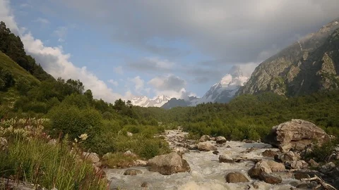 Movement of clouds and water flows in a stormy river in the mountains Stock Footage 86488450