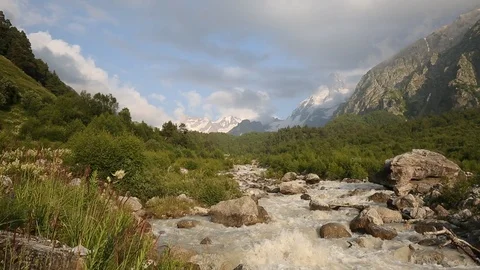 Movement of clouds and water flows in a stormy river in the mountains Stock Footage 86488889