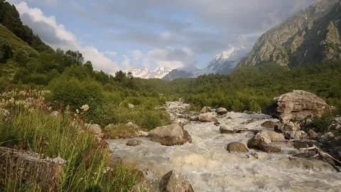 Movement of clouds and water flows in a stormy river in the mountains Stock Footage 86488952