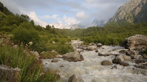 Movement of clouds and water flows in a stormy river in the mountains Stock Footage 86488986