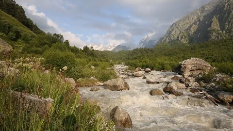 Movement of clouds and water flows in a stormy river in the mountains Stock Footage 86489123