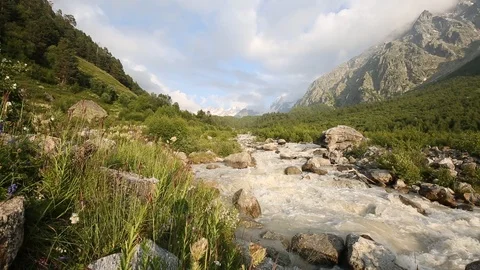Movement of clouds and water flows in a stormy river in the mountains Stock Footage 86489161