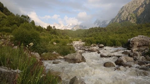 Movement of clouds and water flows in a stormy river in the mountains Stock Footage 86489222