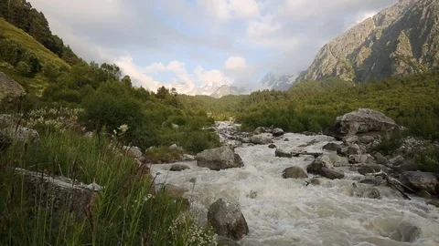 Movement of clouds and water flows in a stormy river in the mountains Stock Footage 86489490