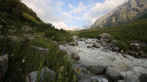 Movement of clouds and water flows in a stormy river in the mountains Stock Footage 86489525