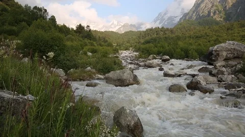 Movement of clouds and water flows in a stormy river in the mountains Stock Footage 86489590