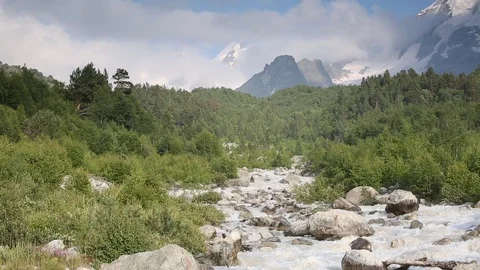 Movement of clouds and water flows in a stormy river in the mountains Stock Footage 86489763