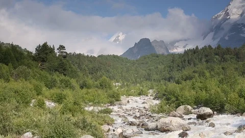 Movement of clouds and water flows in a stormy river in the mountains Stock Footage 86489815
