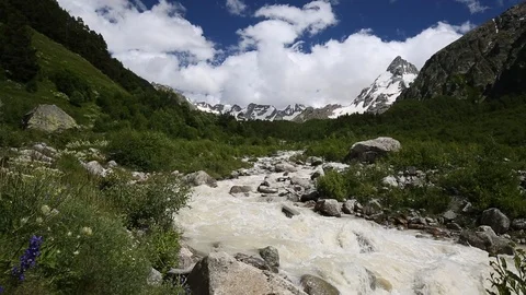 Movement of clouds and water flows in a stormy river in the mountains Stock Footage 86489912
