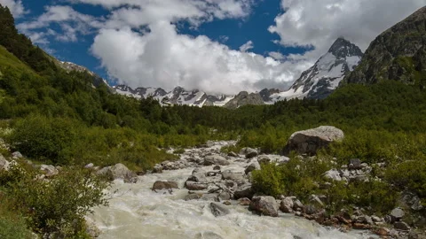 Movement of clouds and water flows in a stormy river in the Caucasus mountais Video stock 86990214