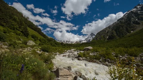 Movement of clouds and water flows in a stormy river in the mountains Video stock 86991245