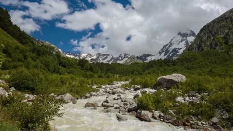 Movement of clouds and water flows in a stormy river in the mountains Video stock 86991285