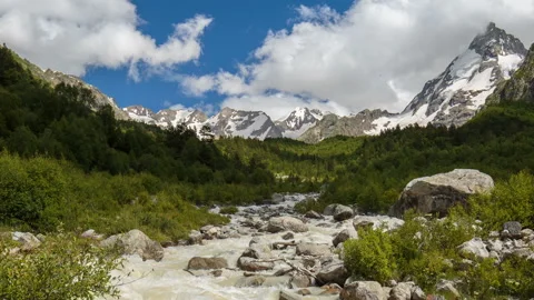 Movement of clouds and water flows in a stormy river in the Caucasus mountais Video stock 86994041