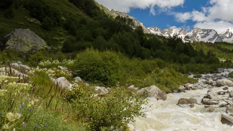 Movement of clouds and water flows in a stormy river in the Caucasus mountais Video stock 86994233