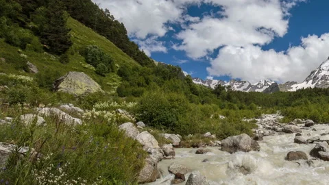 Movement of clouds and water flows in a stormy river in the Caucasus mountais Video stock 86994380