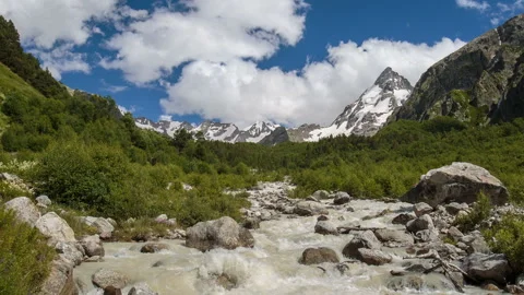 Movement of clouds and water flows in a stormy river in the Caucasus mountais Video stock 86994385