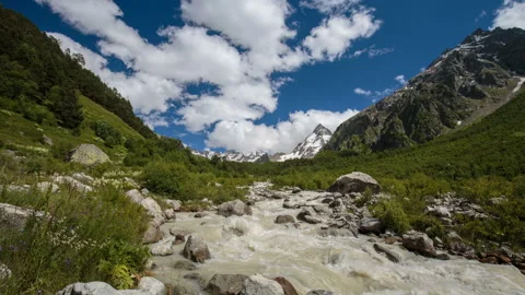 Movement of clouds and water flows in a stormy river in the mountains Video stock 86994595