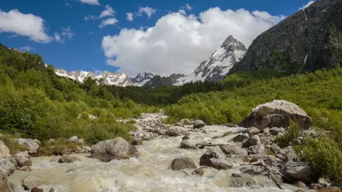 Movement of clouds and water flows in a stormy river in the mountains Stock Footage 86994739