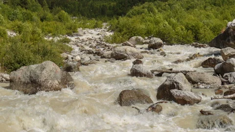 Movement of clouds and water flows in a stormy river in the Caucasus mountais Video stock 86994757