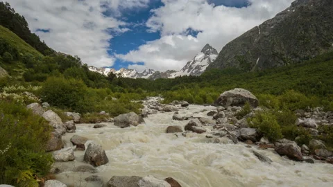 Movement of clouds and water flows in a stormy river in the mountains Video stock 86995076